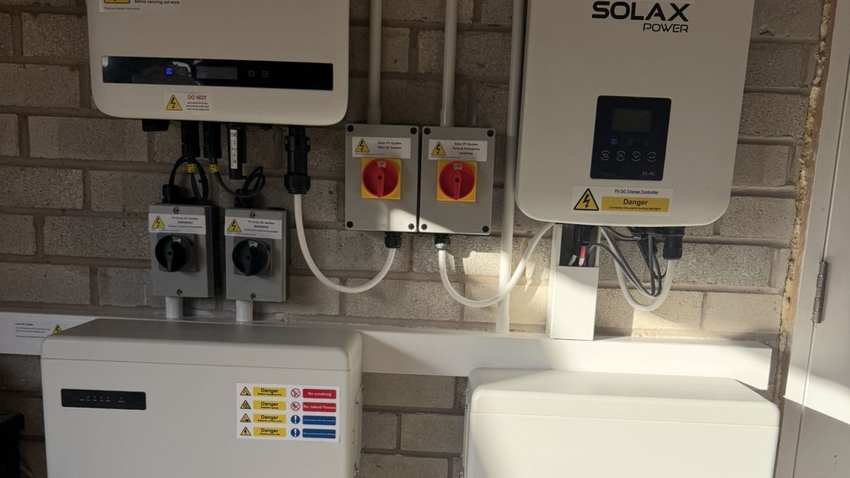 Two inverters and two batteries we installed on a garage wall in St Helens